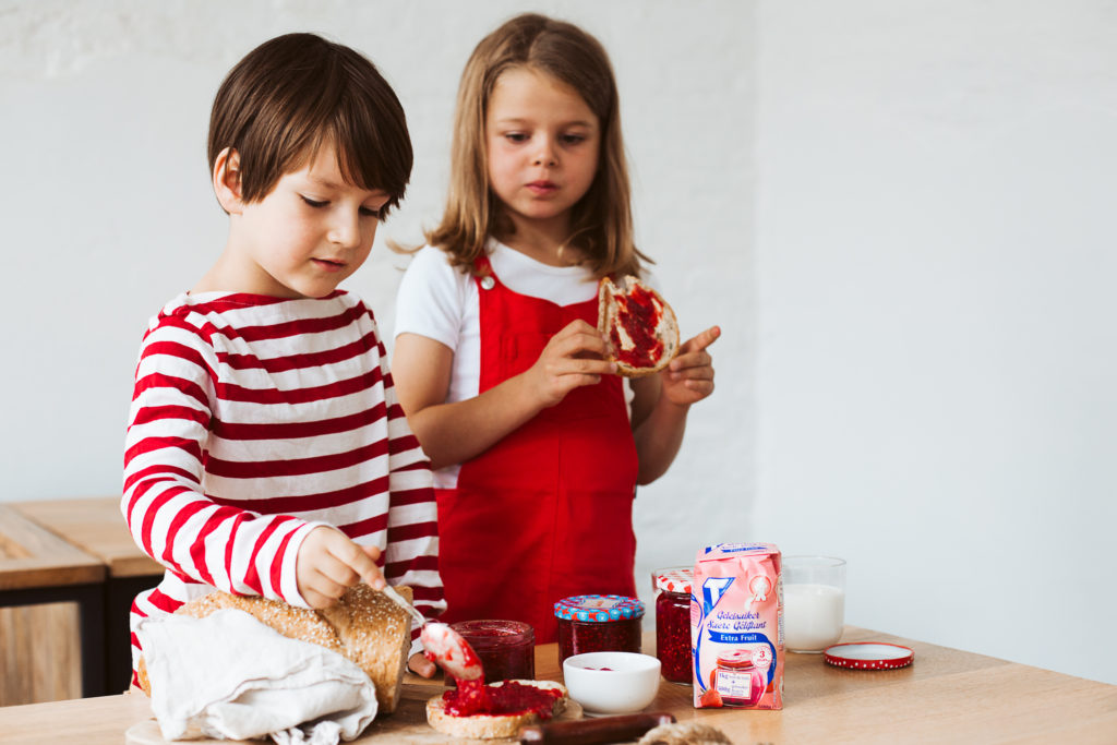 2 kinderen smeren een boterham met confituur geleisuiker Tiense Suiker